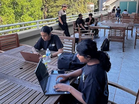 A group of students working at the June 2023 Rising C-Suites Business Hackathon